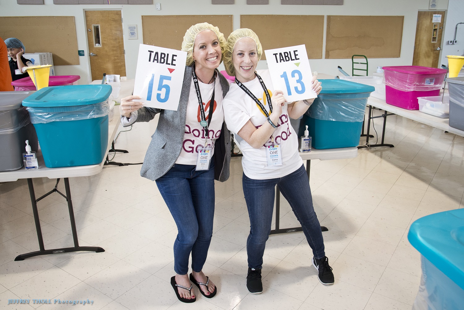 Volunteers from the Jewish Federation of South Palm Beach County smile wide during a food drive.