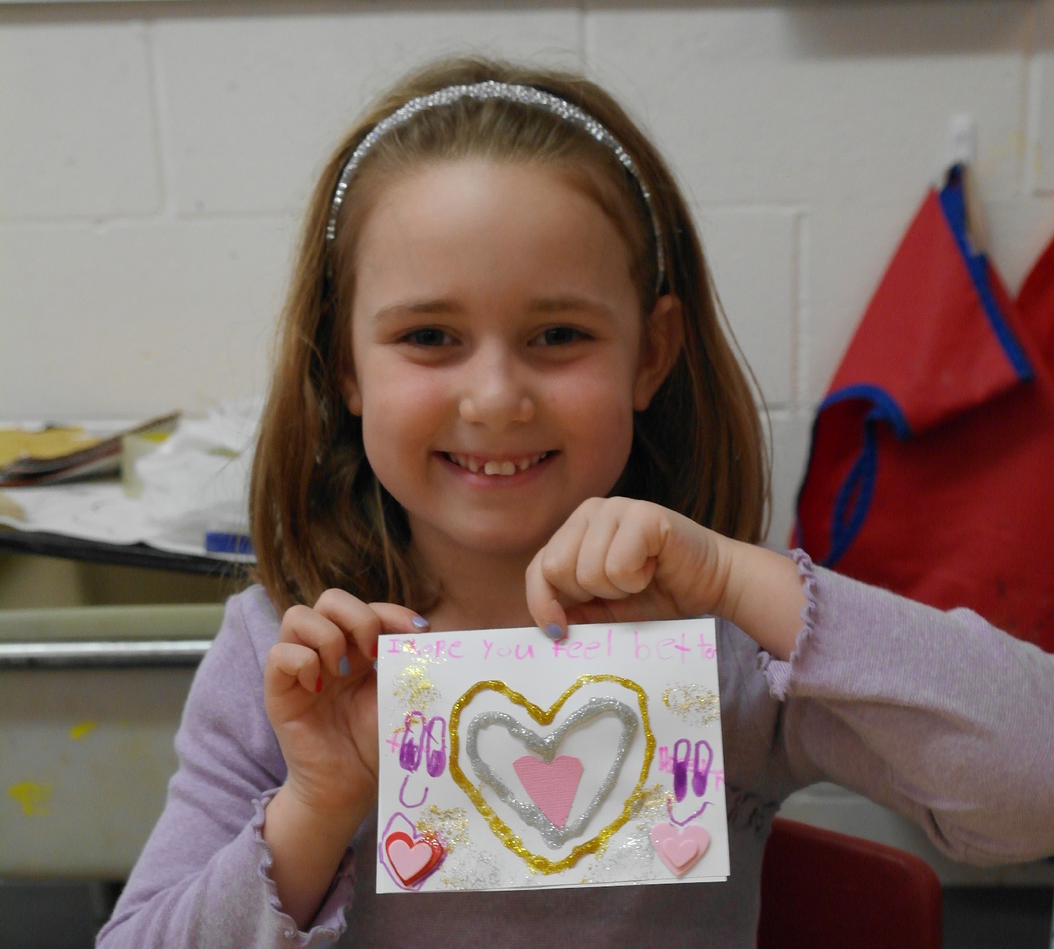 Smiling volunteer from Temple Sinai in Toronto makes a love note.