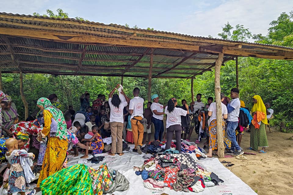 Distributing clothes, shoes, and bags to the locals.